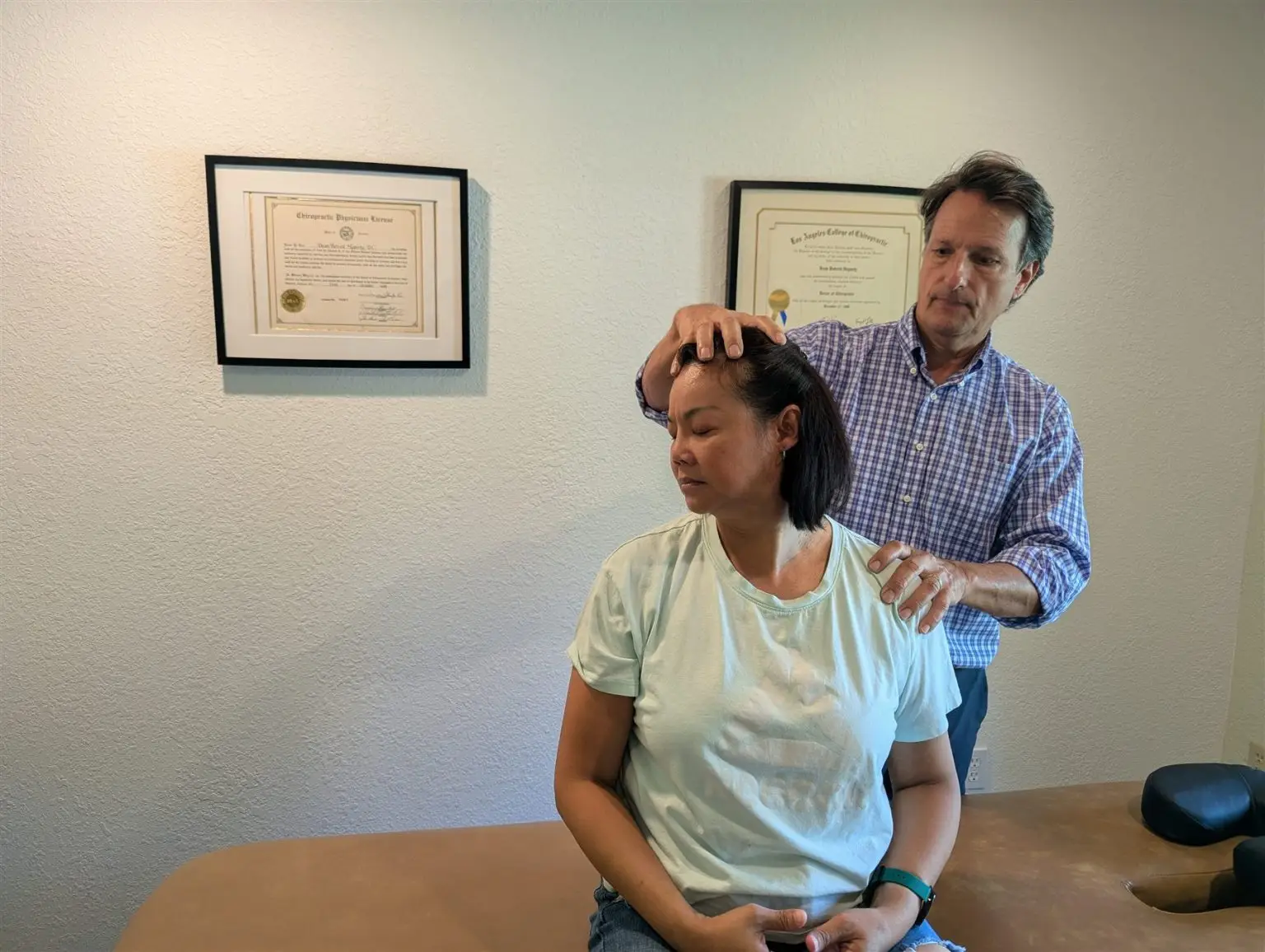 Patient receiving a gentle neck adjustment during her first visit at Spinal Solutions Chiropractic